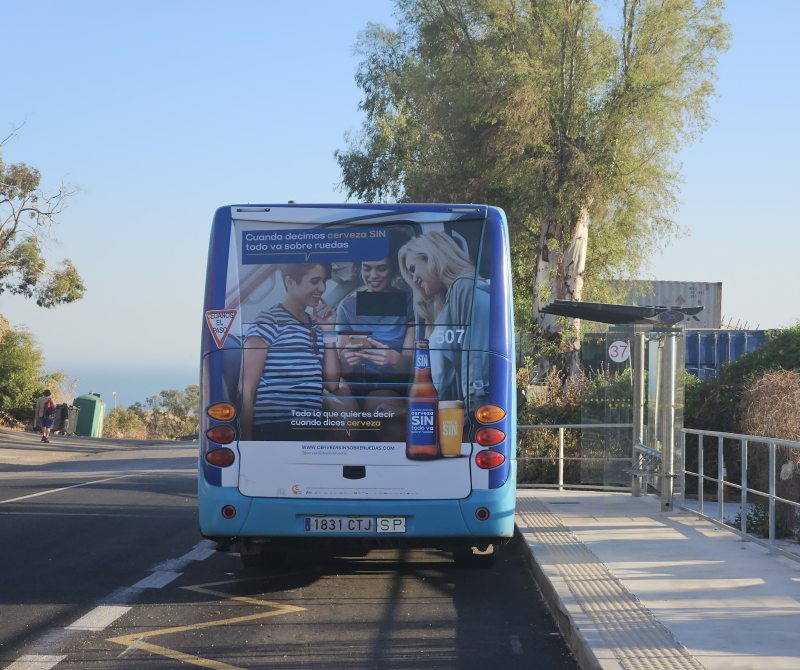 Photo of a bus parked at a bus stop with a shelter